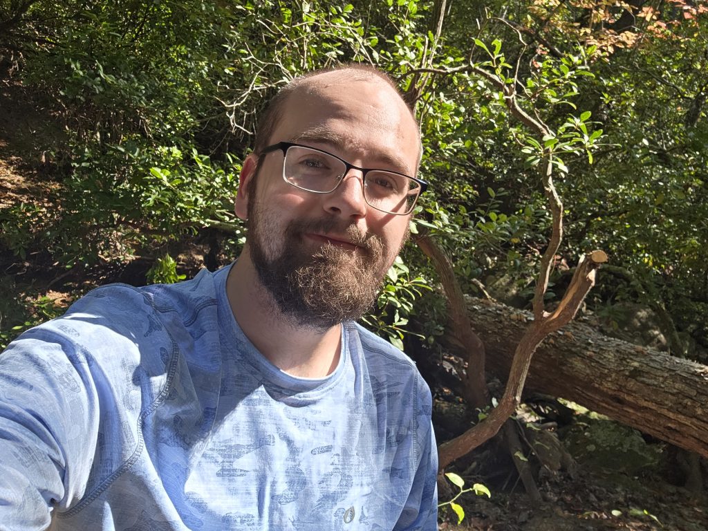 Senpai sitting on a log.