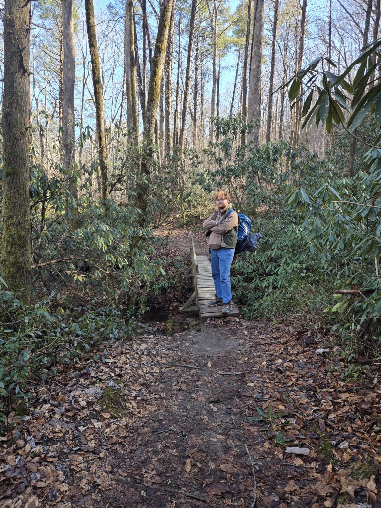 Big Red man hiking the trail.